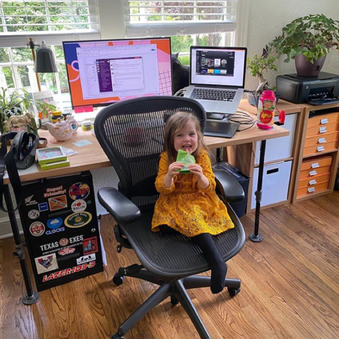 Small child sitting at a desk smiling