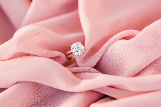Diamond ring on pink, plush fabric