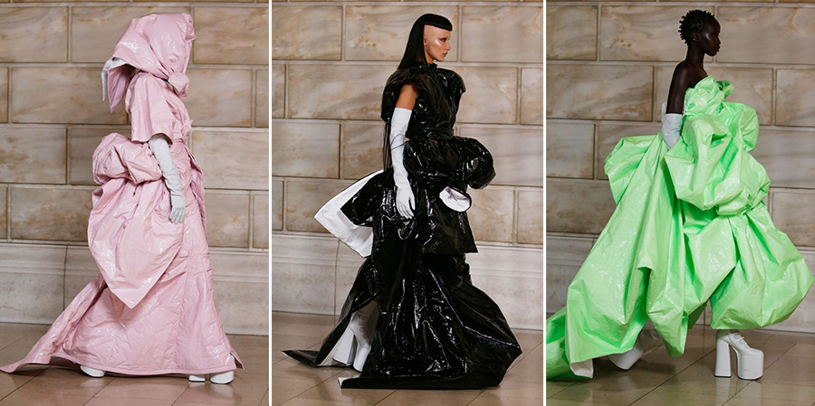 Runway models wearing big, baggy dressed made of a vinyl-like material.